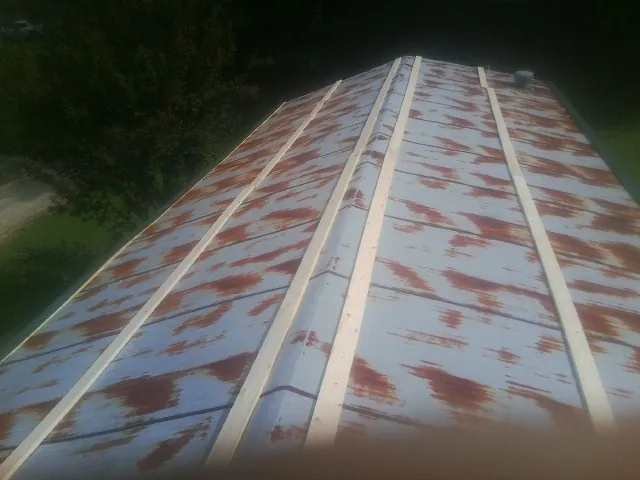 Rusted metal roof panels with new wood purlins before replacement — Storm Damage Roof Repair in Virginia Beach by Roofing Brothers